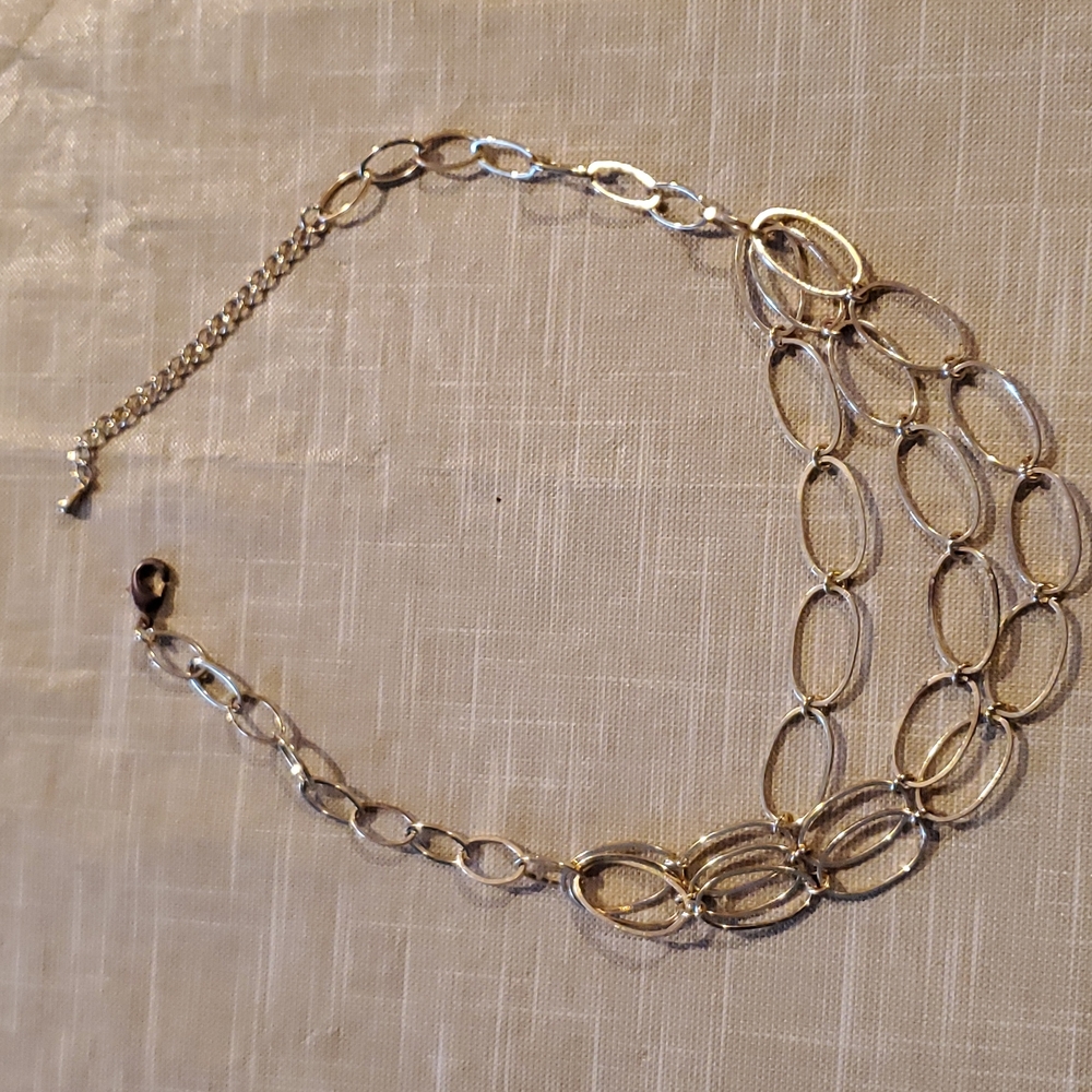 Triple strand gold tone necklace.  18 inch